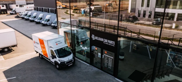 DISTRIGO-bestelwagen bij het Belgian Car Parts gebouw in Zele, een logistiek centrum voor auto-onderdelen.